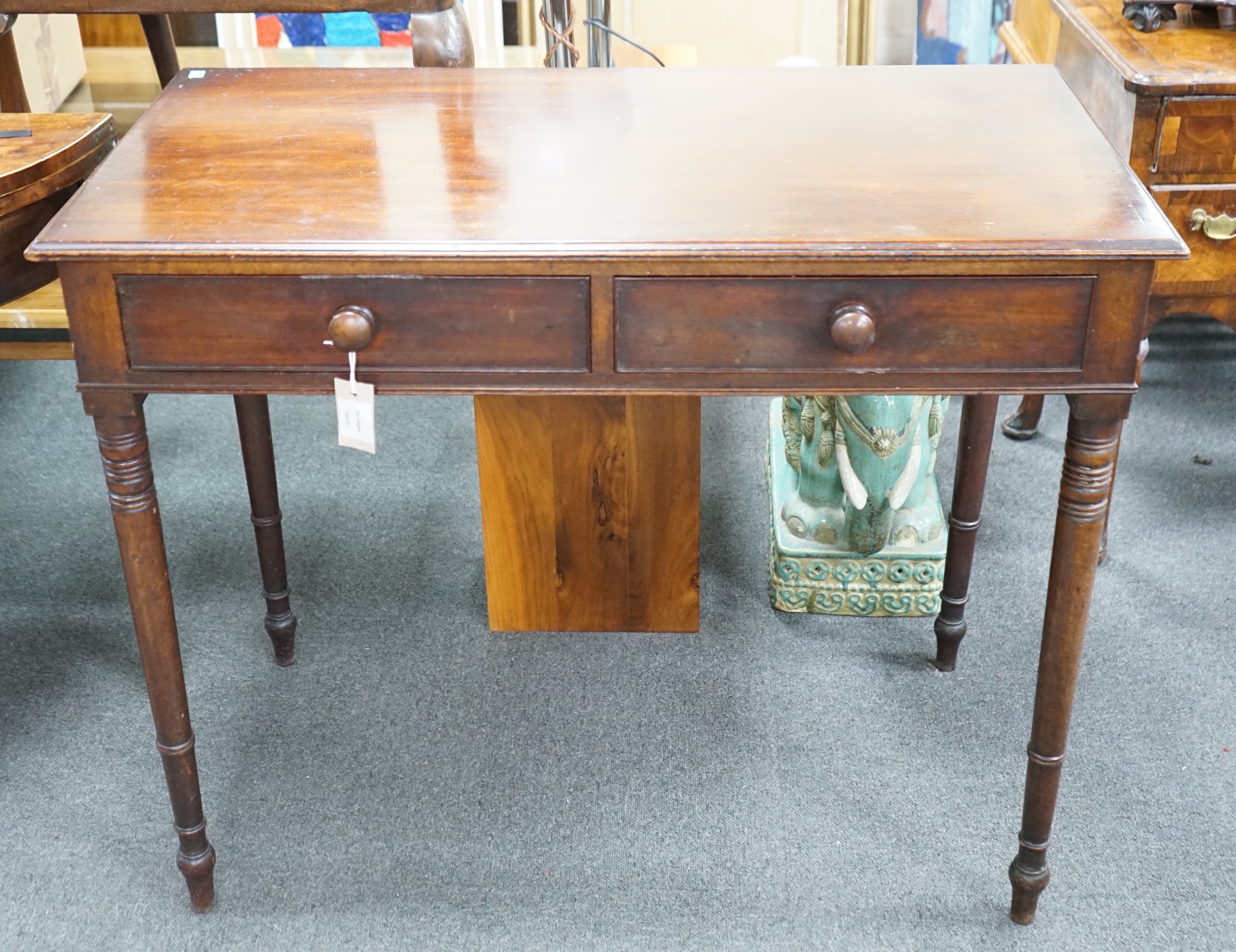 A Regency mahogany two drawer side table with moulded edge on turned legs, width 95cm, depth 51cm, height 78cm